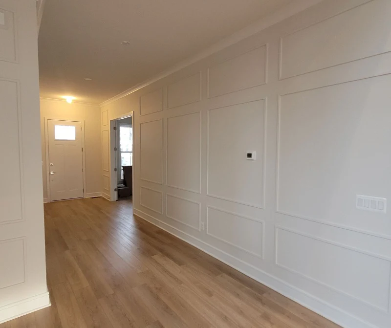 Finished white walls in a home hallway after Five Star Painting's drywall carpentry services.