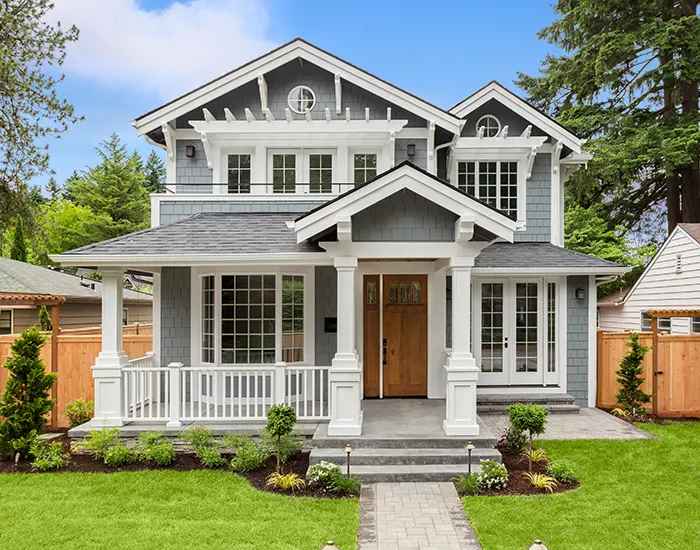 Grey and white Craftsman style house after exterior carpentry services from Five Star Painting.