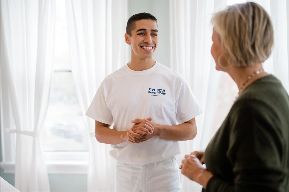 Five Star Painting painter consulting with homeowner.