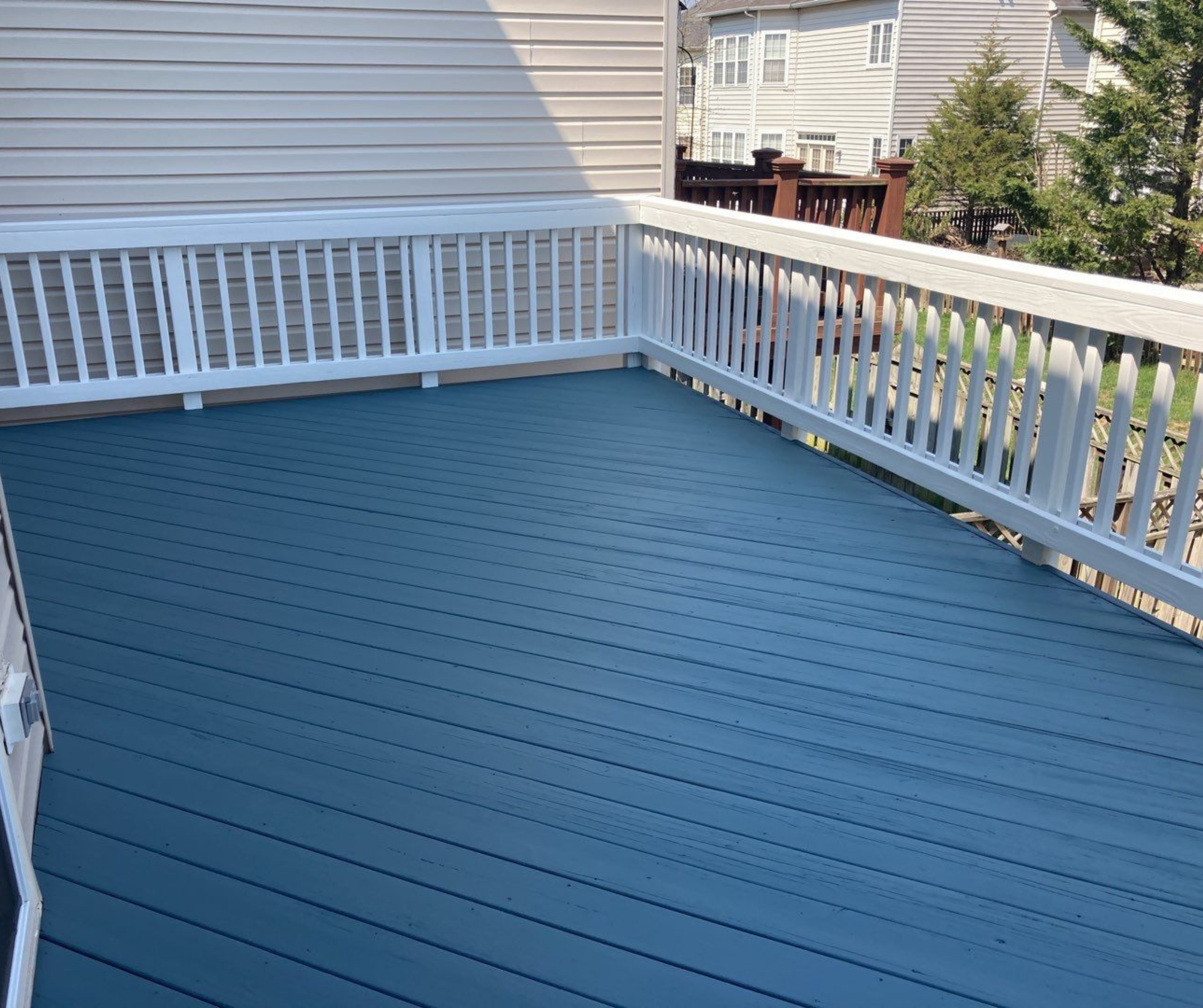 Large off-white patio after deck staining service from Five Star Painting 